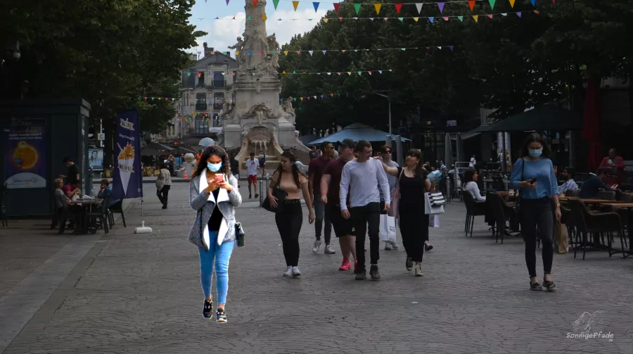 pedestrians stroll through the city of Reims with handbags and daypacks - should pay attention with anti pickpocket bag