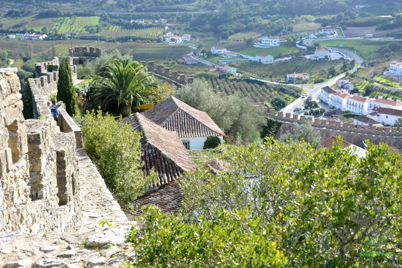 narrow pedestrian trail on the Obidos town wall with view on to the surroundings