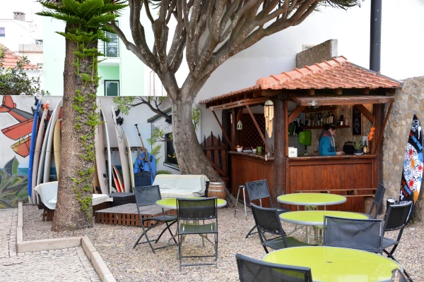 Hostels in Peniche are prepared for surfers with garden bar an surfboard - store