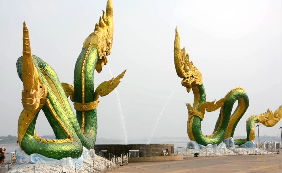 Nong Khai attraction water spouting dragons on the boardwalk
