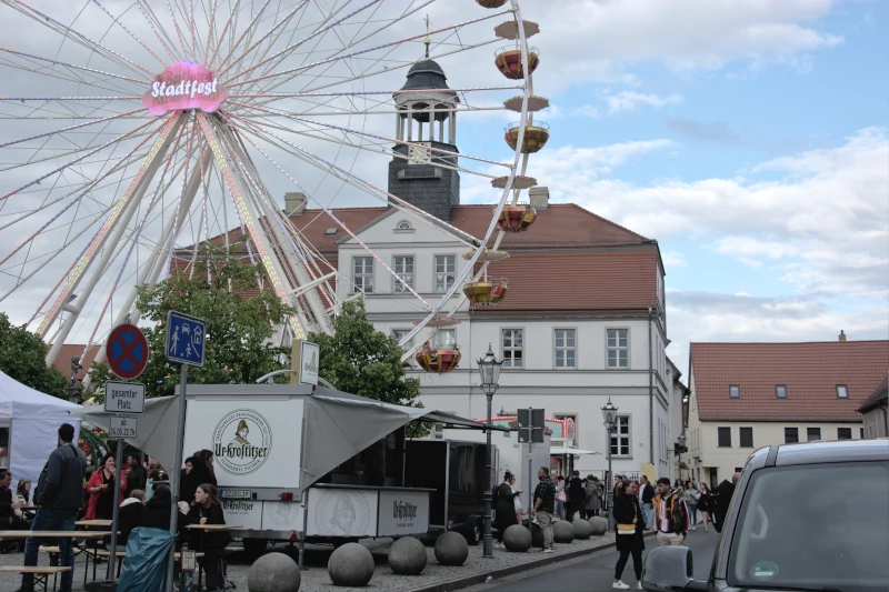 Bad Düben town hall with ferris wheel from the town festival