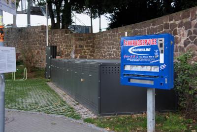 Locable bike boxes and a tube vending machine near Kändlerpark / westside of Old town bridge
