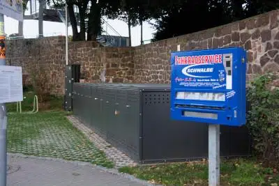 Locable bike boxes and a tube vending machine near Meissen old town bridge at the Elbe river cycle way