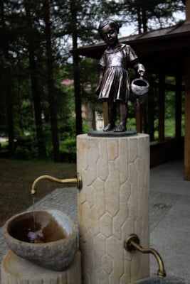 Girl sculpture on the healing well "Pijalka" in Czarniawa Zdrój