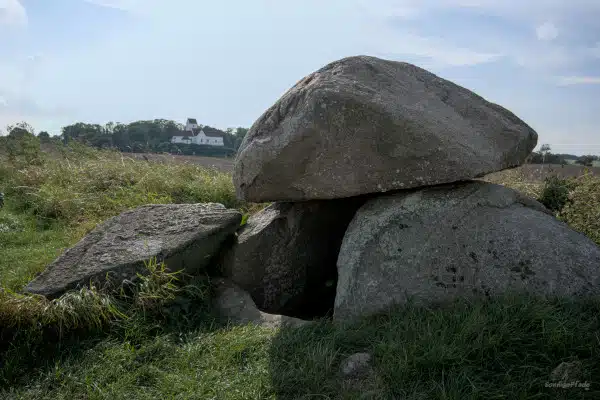Entrance stones on neolithic Kong humbles grave - the church of Humble in the back - sights in south of Danish Langeland